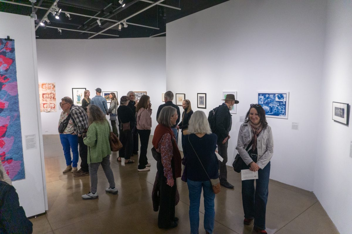 Event attendees, including artists of pieces on display, view artworks at "Under Pressure", part of the 2026 National Printmaking Exhibition at the Lincoln Center March 7. The exhibition occurs biannually. Pieces in this showcase were selected by Colorado State University Associate Professor Johnny Plastini.