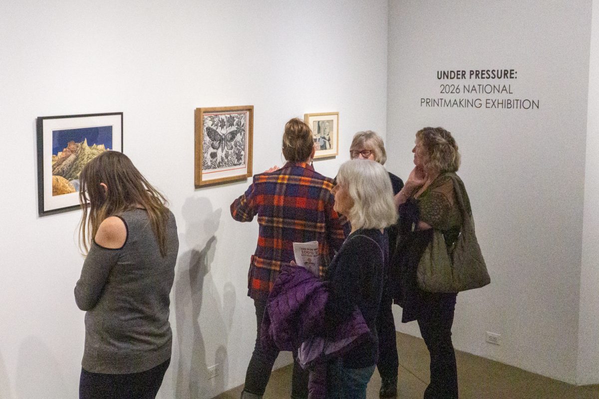 Event attendees, including artists of pieces on display, view artworks at "Under Pressure", part of the 2026 National Printmaking Exhibition at the Lincoln Center March 7. The exhibition occurs biannually. Pieces in this showcase were selected by Colorado State University Associate Professor Johnny Plastini.