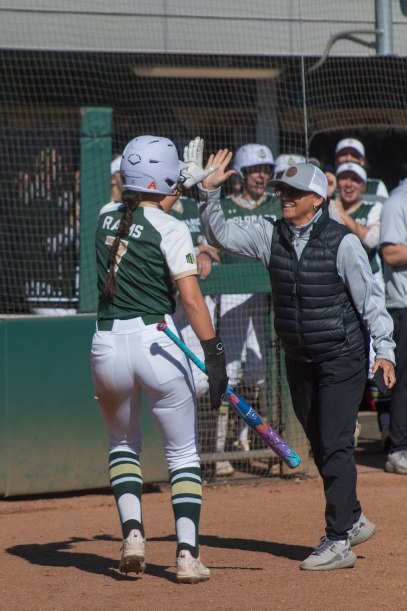 Sophomore Autumn Rutherford high-fives head coach Jen Fisher after scoring a home run during Colorado State University’s game against the Univeristy of South Dakota Mar. 3. The Rams won this game 4-2.