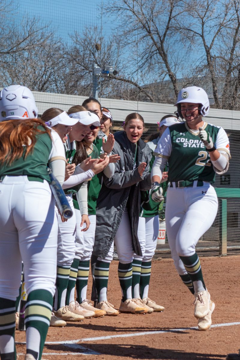 Colorado State Univeristy softball players cheer on their teammate, sophomore Kyra Smith, as she runs to home during Colorado State University’s game against the University of South Dakota Mar. 3.