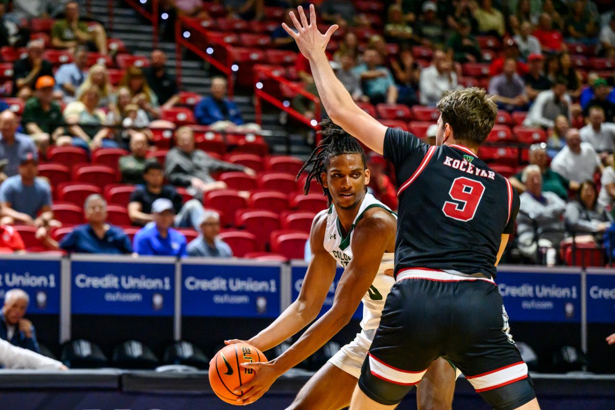 Colorado State University men's basketball forward Carey Booth (0) looks around Fresno State University center Gasper Kocevar (9) for a teammate during CSU's game against FSU in the Mountain West tournament March 11. Booth put 18 points on the board for the Rams during the game. 