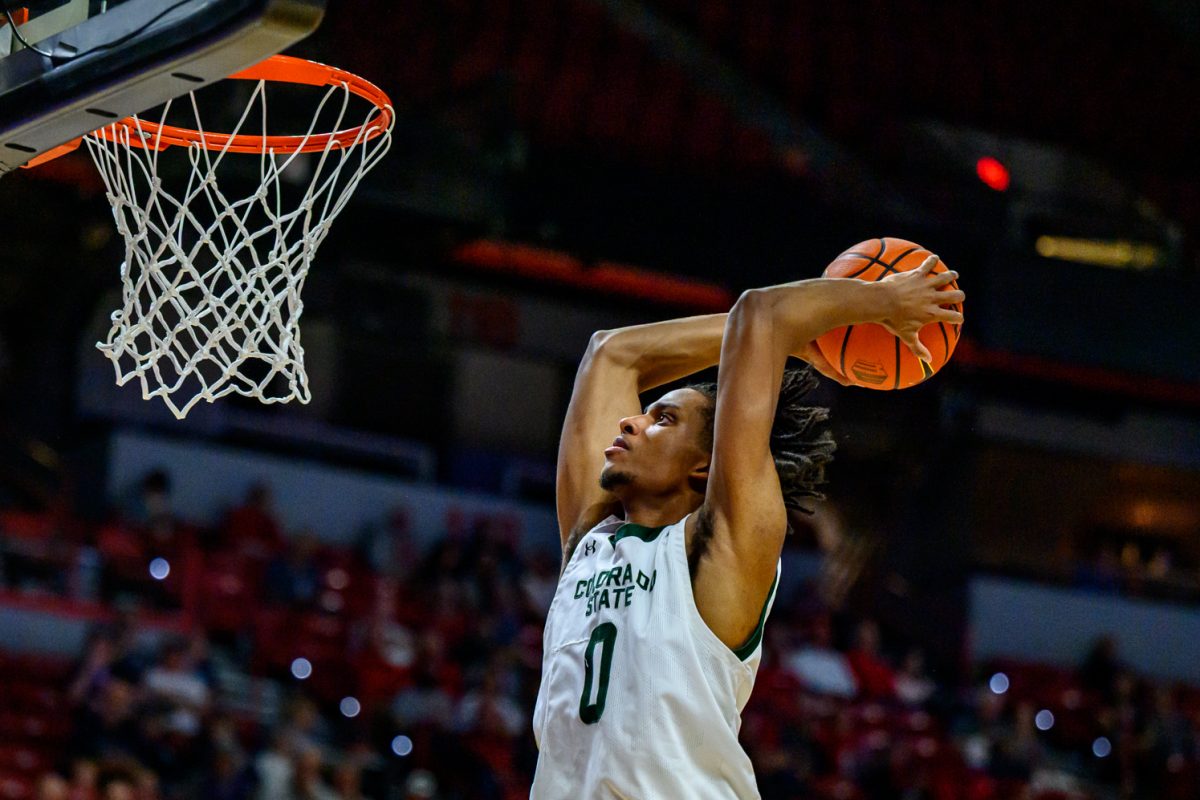 Colorado State University men's basketball forward Carey Booth (0) leaps up to dunk the ball during CSU's game against Fresno State University in the Mountain West tournament March 11. 