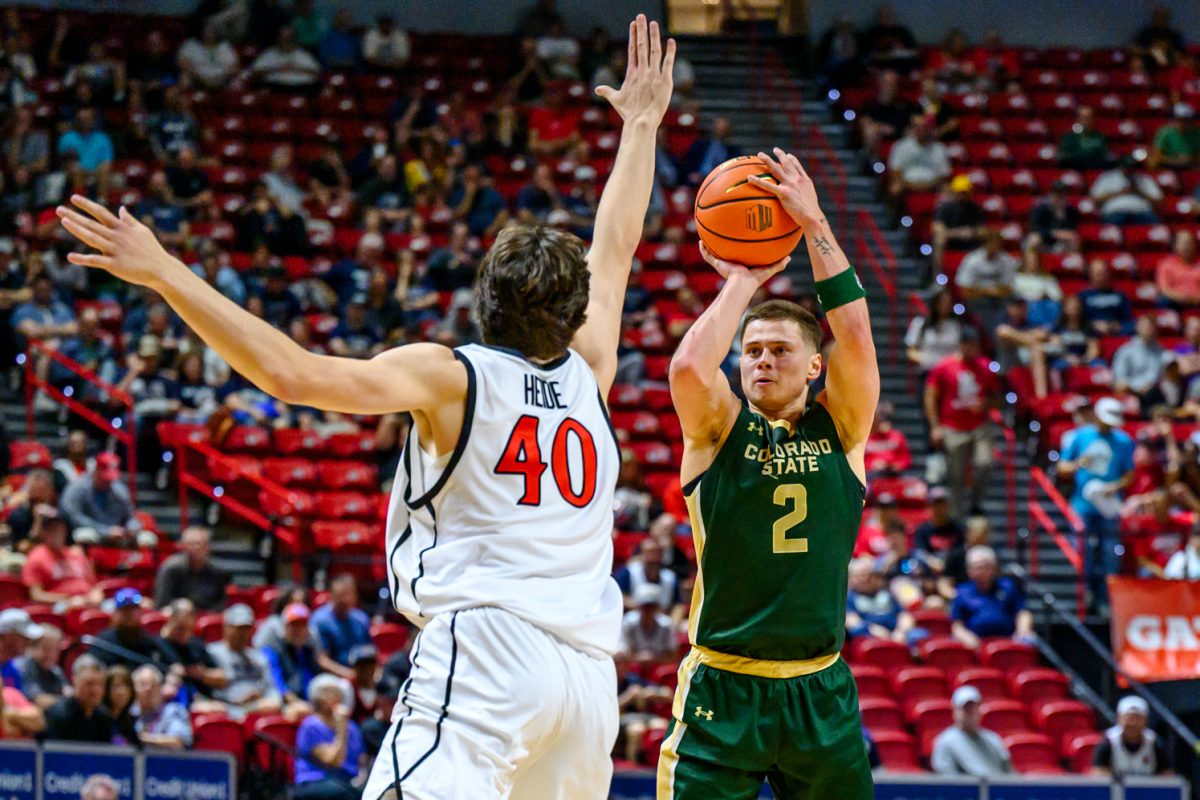 Colorado State University men's basketball guard Brandon Rechsteiner (2) lines up a 3-pointer while facing pressure from San Diego State University forward Miles Heide (40) in the Mountain West tournament March 12. 