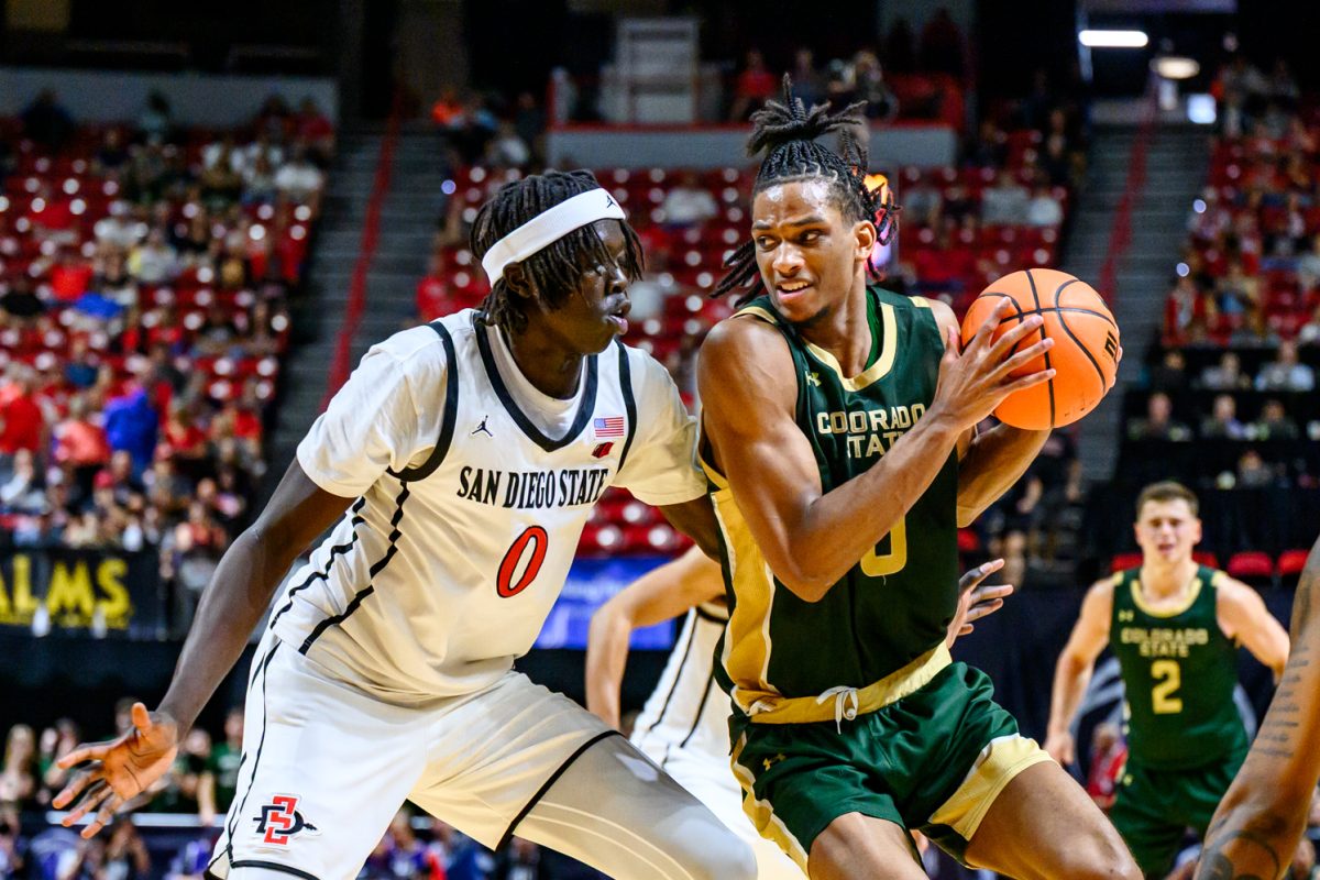 Colorado State University men's basketball forward Carey Booth (0) looks for a way around San Diego State University forward Magoon Gwath (0) during CSU's game against SDSU in the Mountain West tournament March 12. 