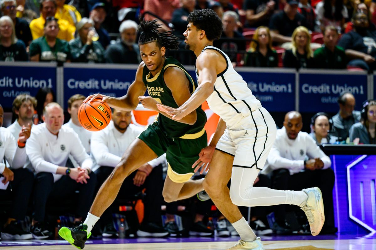 Colorado State University men's basketball forward Carey Booth (0) pushes through a San Diego State University defender during CSU's Mountain West tournament game against SDSU March 12. Booth scored seven points for the Rams.