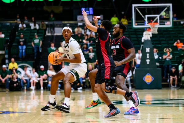 Colorado State University men's basketball guard Jojo McIver (8) looks for a teammate to pass to while facing pressure from Saint Joseph's University defenders during CSU's game against SJU in the National Invitation Tournament March 18. 