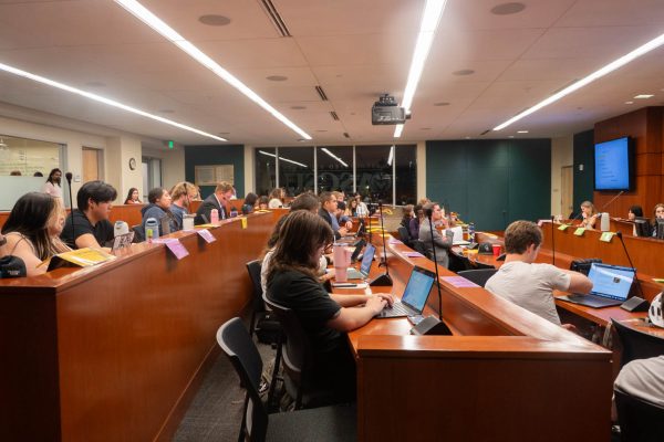 The gathered members of the Associated Students of Colorado State University Senate watch as the speaker moves the chamber to a discussion of executive reports, following the conclusion of the guest speaker's presentation March 25.