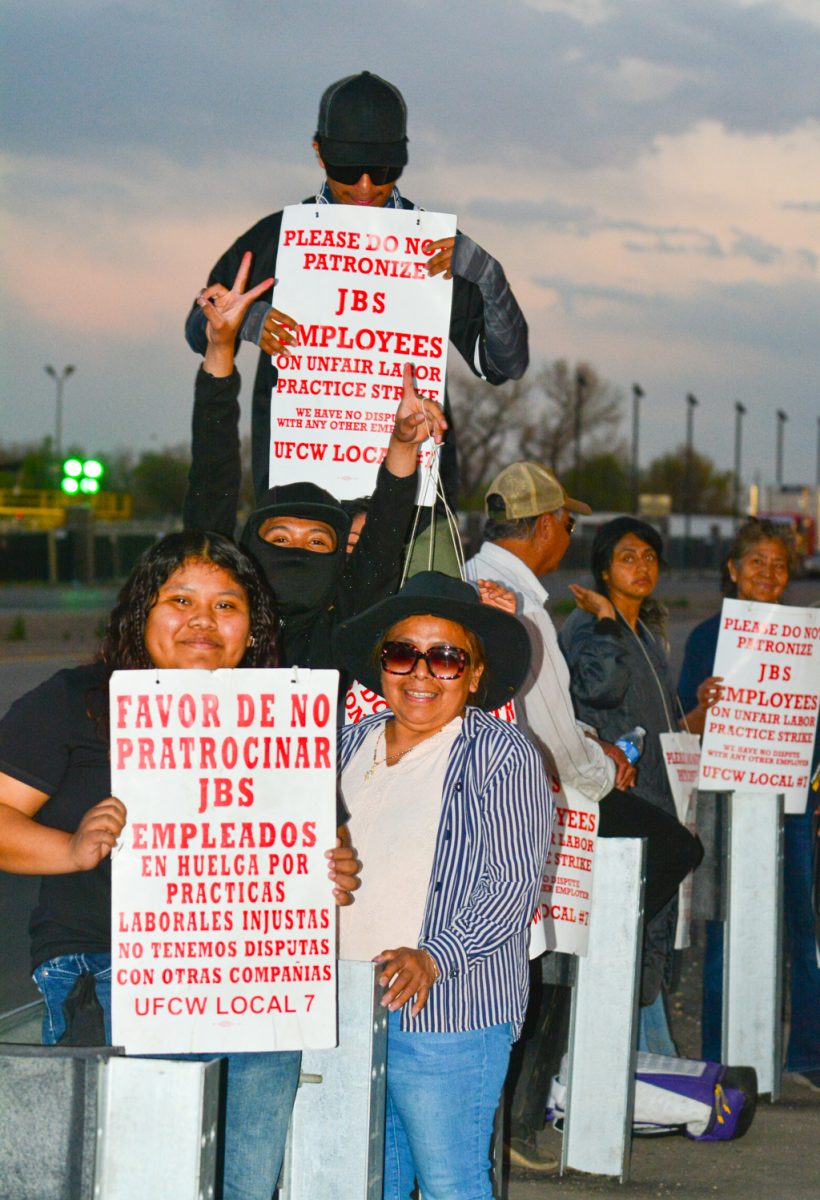 Protestors pose for a photo as they stand in front of JBS to be a part of the massive two weeklong strike to fight against the unfair work conditions March. 25. These protestors have showed up before and after work to fight for better work conditions after JBS increased their production line to fit in a certain time limit, so the company did not have to pay them their usual hours leading to a significant pay cut as well. 