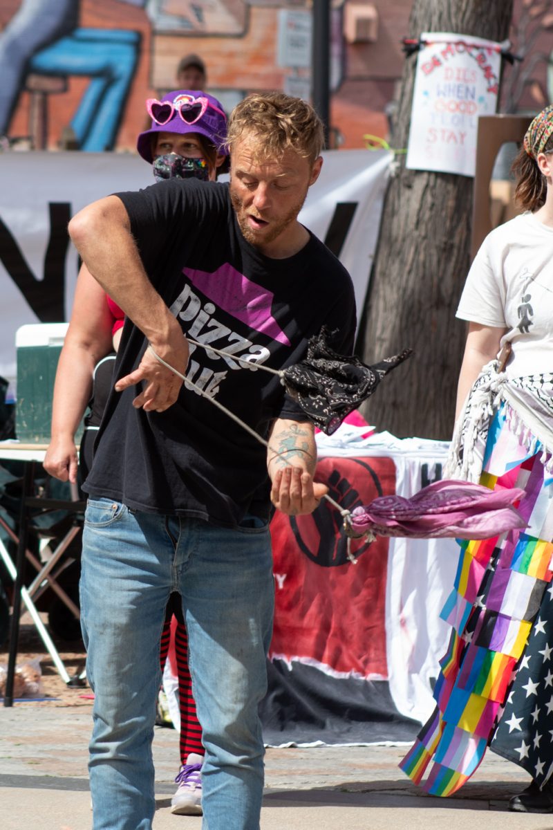 David ‘Sparky’, dances with scarves during the No Colonizers mutual aid event let by the Colorado State University Young Democratic Socialists of America, and CSU Students for Justice in Palestine in Oak Street Plaza Mar. 28. “I love the fact that there are so many rallies here and so many peaceful protests. It’s a chance to take part in history, you know what I’m saying? This is a moment that can turn the entire United States. I wouldn’t miss that for the world,” Sparky said.