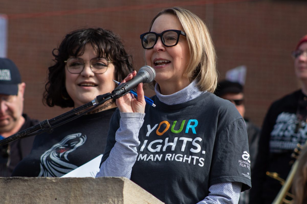 Victoria Silva and Karrin Anderson speak to a crowd during the No Kings protest in Fort Collins’ Civic Center Park March 28. Silva is a Biochemistry Student at Colorado State University and founder and president of CSU STEM Interdisciplinary Ram Alliance, and Anderson is a Professor of Communications Studies at CSU and spokesperson for the CSU chapter of the American Association of Univeristy Professors. “This is a community event. Community, not kings,” Anderson said.