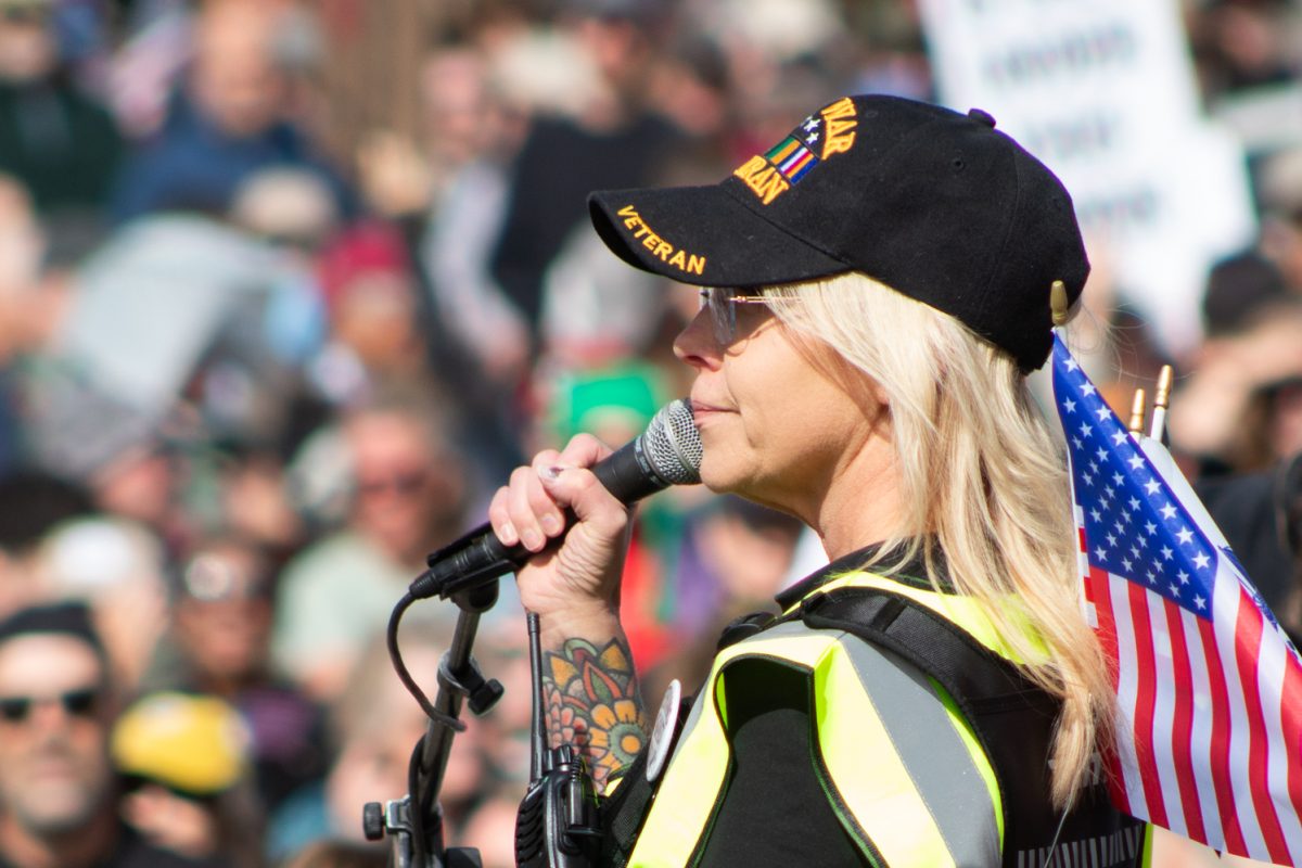 A member of Northern Colorado Veterans Against Kings speaks to veterans in a crowd of No Kings protesters, urging them to join in solidarity at the front of the march, in Civic Center Park March 28. 