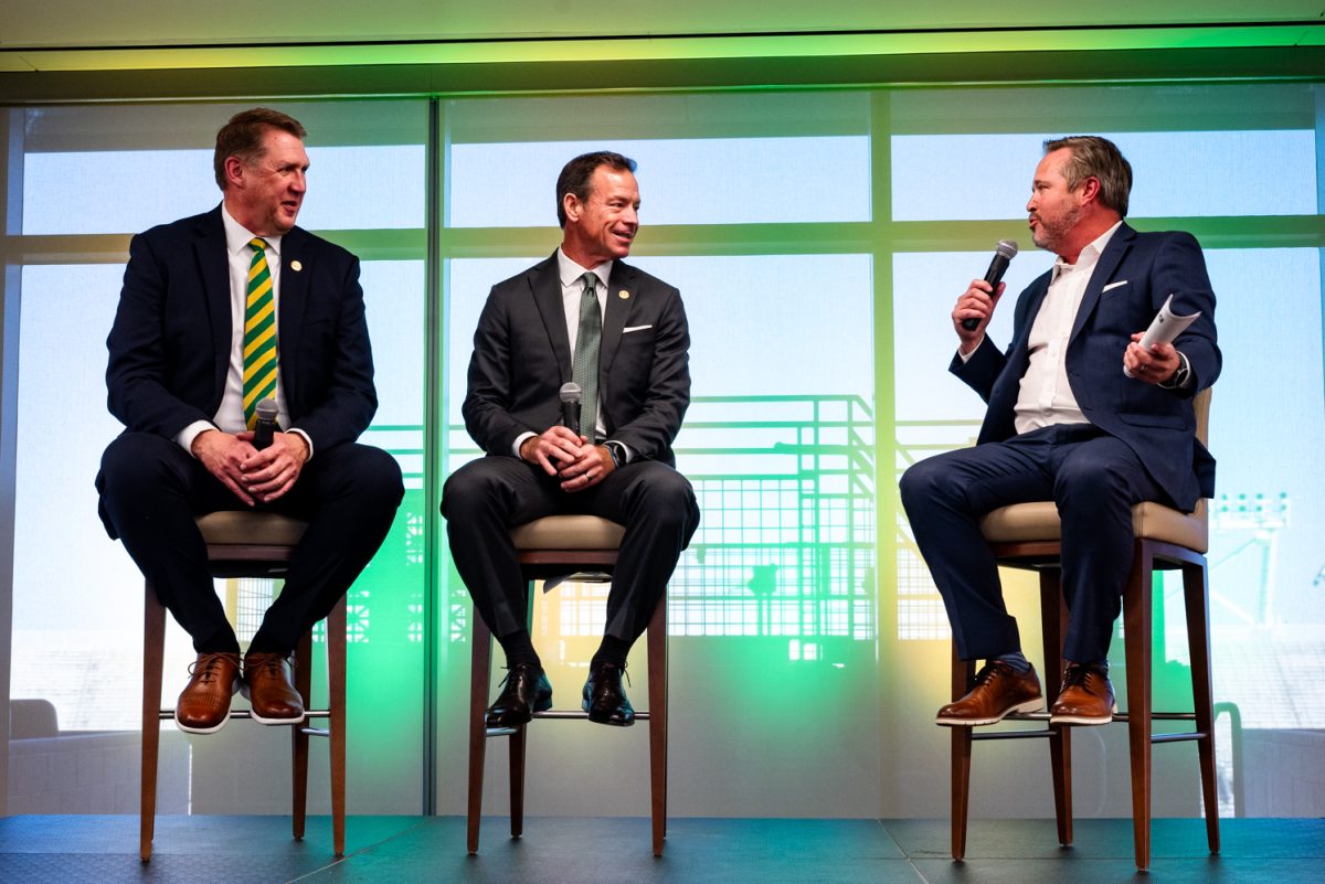 Voice of the Rams Brian Roth asks Colorado State University head football coach Jim Mora a question during a press conference in Canvas Stadium Dec. 1.