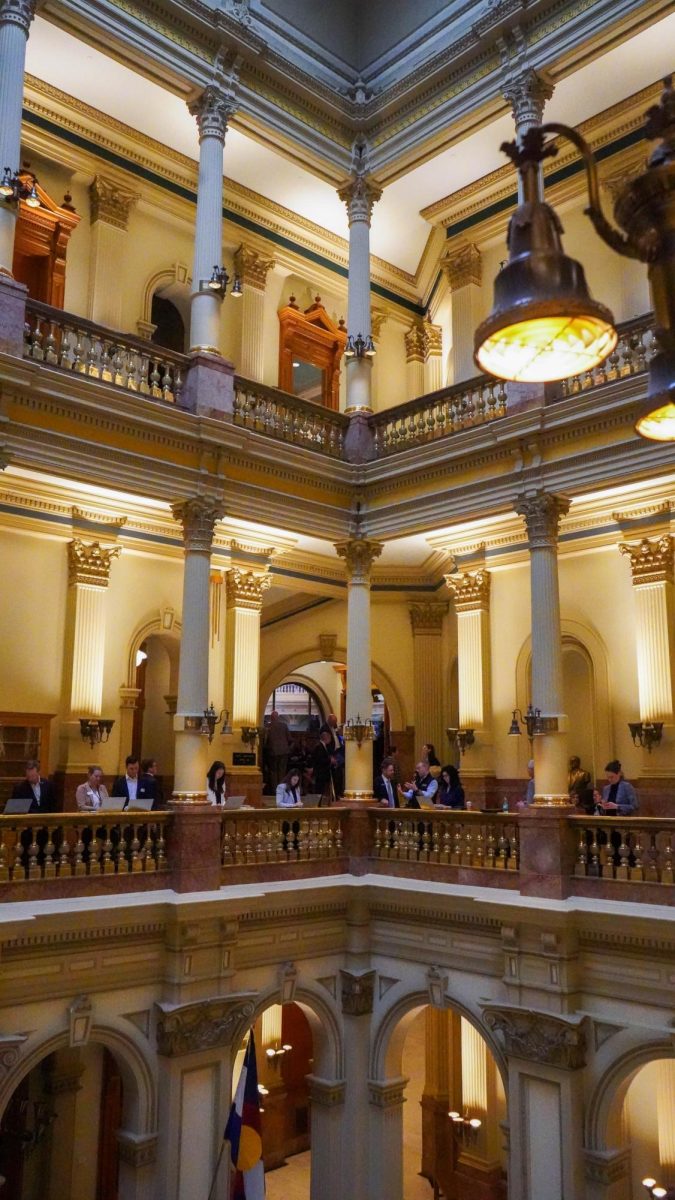 Staffers of the Colorado General Assembly work March 31 during the legislative session in the Colorado Capitol.