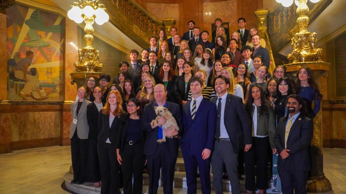 Colorado Gov. Jared Polis and his dog pose with the Associated Students of Colorado State University and guests on March 31. Polis visited with students as part of the Day at the Capitol event. 