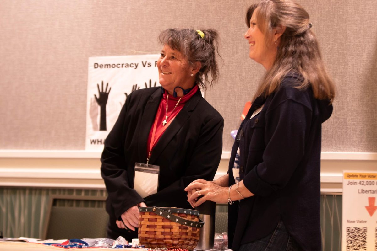 Civic Engagement Fair representative Cindy Dronapple laughs with participant at Colorado State University in the Lory Student Center, March 9. "[students] need to get involved to make a difference in how they're going to be affected." Said Donapple.