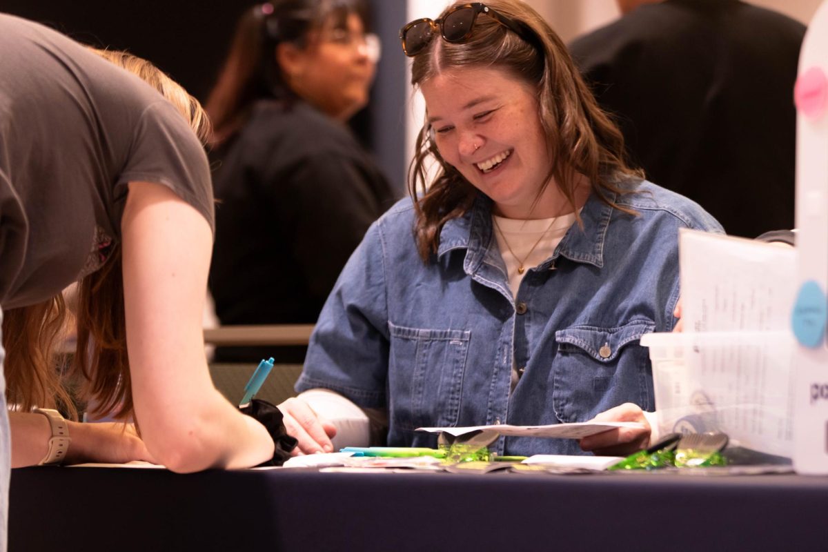 Poudre Libraries representative, Sarah Melbwhite laughs and informs students of current opportunites at the Civic Engagement Fair at Colorado State University in the Lory Student Center, March 9. "it's fun to see people engaging in a civic way." Said Melbwhite.