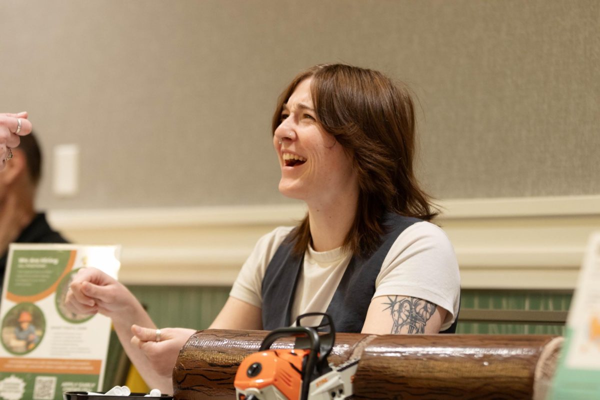 Larimer County representative Kiera Denehan informs participants of opportunites while laughing at Colorado State University's Civic Engagement Fair at the Lory Student Center, March 9. "I think this is just so refreshing to see people who are actively engaging and seeing those opportunities." Said Denehan.