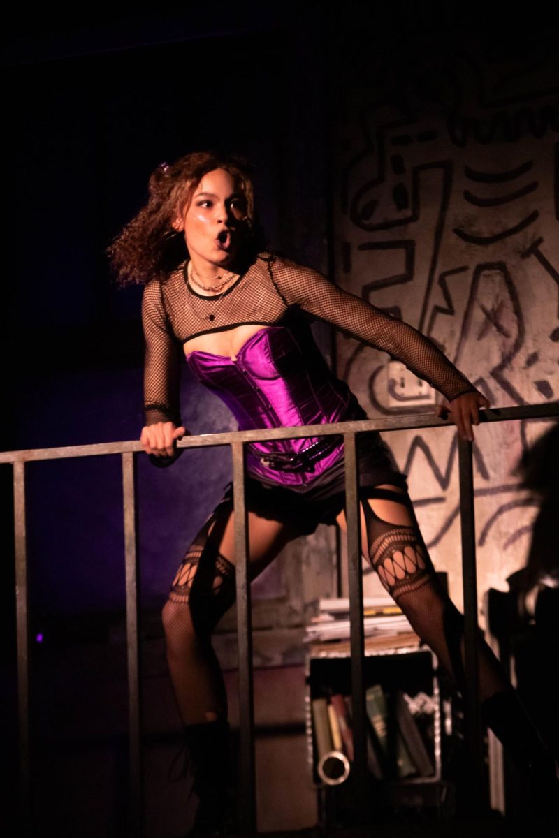 Colorado State University theater major and actor plays "Mimi" leaning over a railing during a dancing scene in Rent musical dress rehearsal in the University Center of the Arts, March 5.