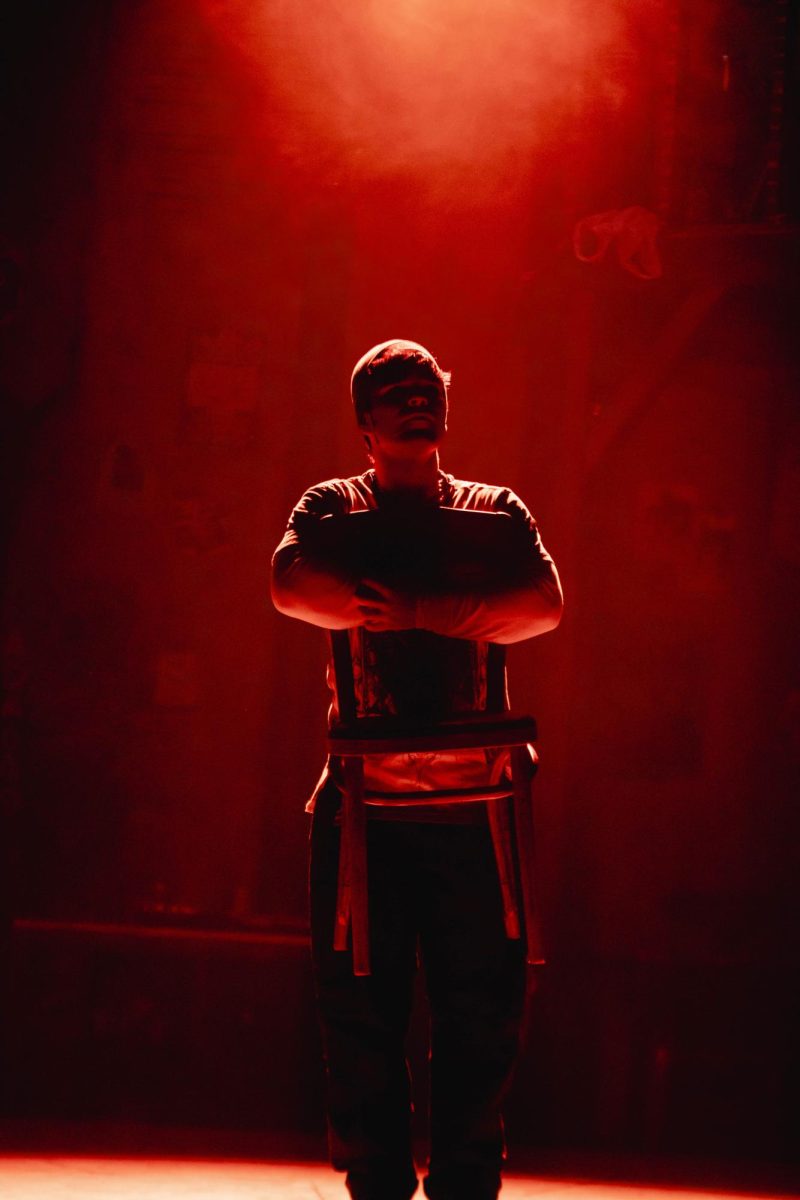Colorado State University Thater major and actor holds a chair during an emotional moment during Rent musical dress rehearsal in the University Center of the Arts, March 5.