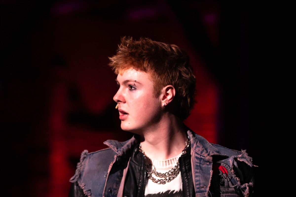Colorado State University theater major and actor plays "Roger" singing during a scene in Rent musical dress rehearsal in the University Center of the Arts, March 5.