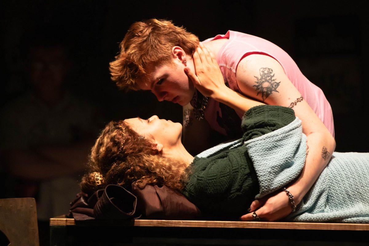 Colorado State University actors play "Mimi" and "Roger" at the end of the Rent musical with "Mimi" laying on a table and "Roger" leaning over her during dress rehearsal in the University Center of the Arts, March 5.