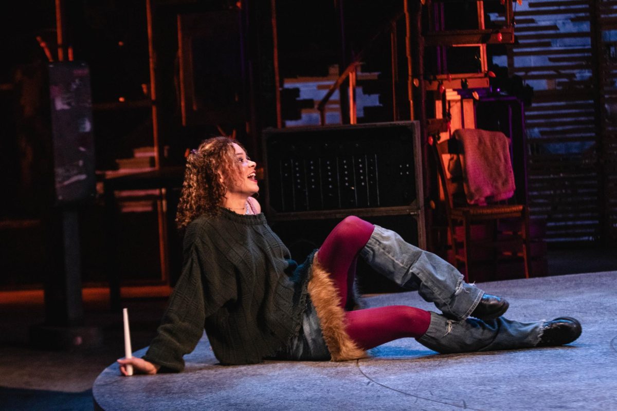 Colorado State University theater major and Rent actor portrays "Mimi" while sitting on the floor singing at the during dress rehearsal at the University Center of the Arts March 5.