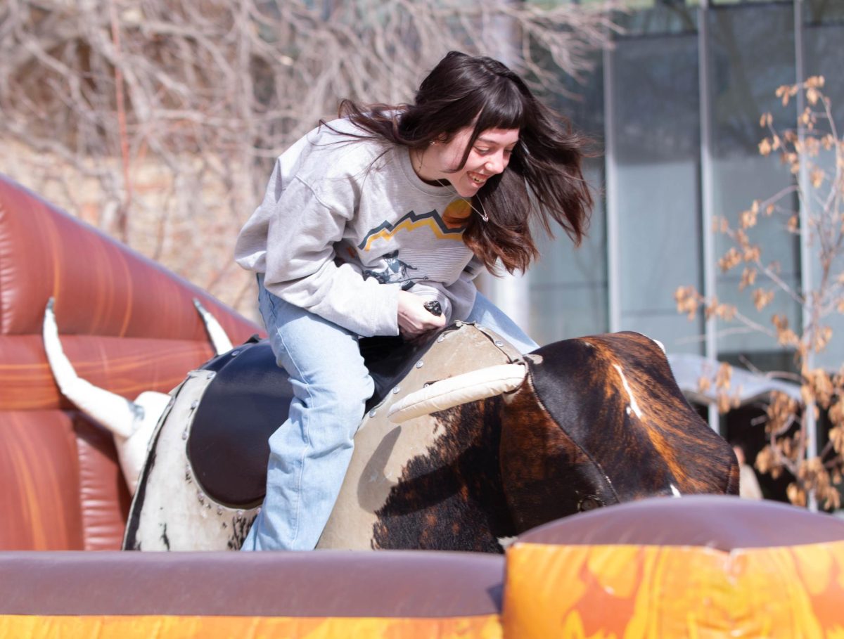 Colorado State University student rides the mechanical bull at ASCSU's Saddle Up and Vote event on the Lory Student Center Plaza, March 10. "I honestly like this better than the ice skating, it's more interesting." Said Colorado State University student Abbie Blunt.