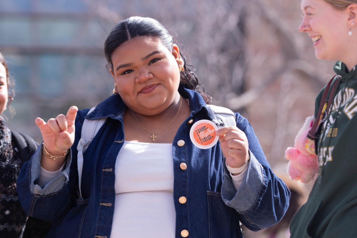 Colorado State University student and ASCSU member Belen Farfan holds up Saddle Up and Vote event sticker, on the Lory Student Center plaza, March 10. "I want to support my peers and encourage everyone to vote because it's so important." Said Farfan.