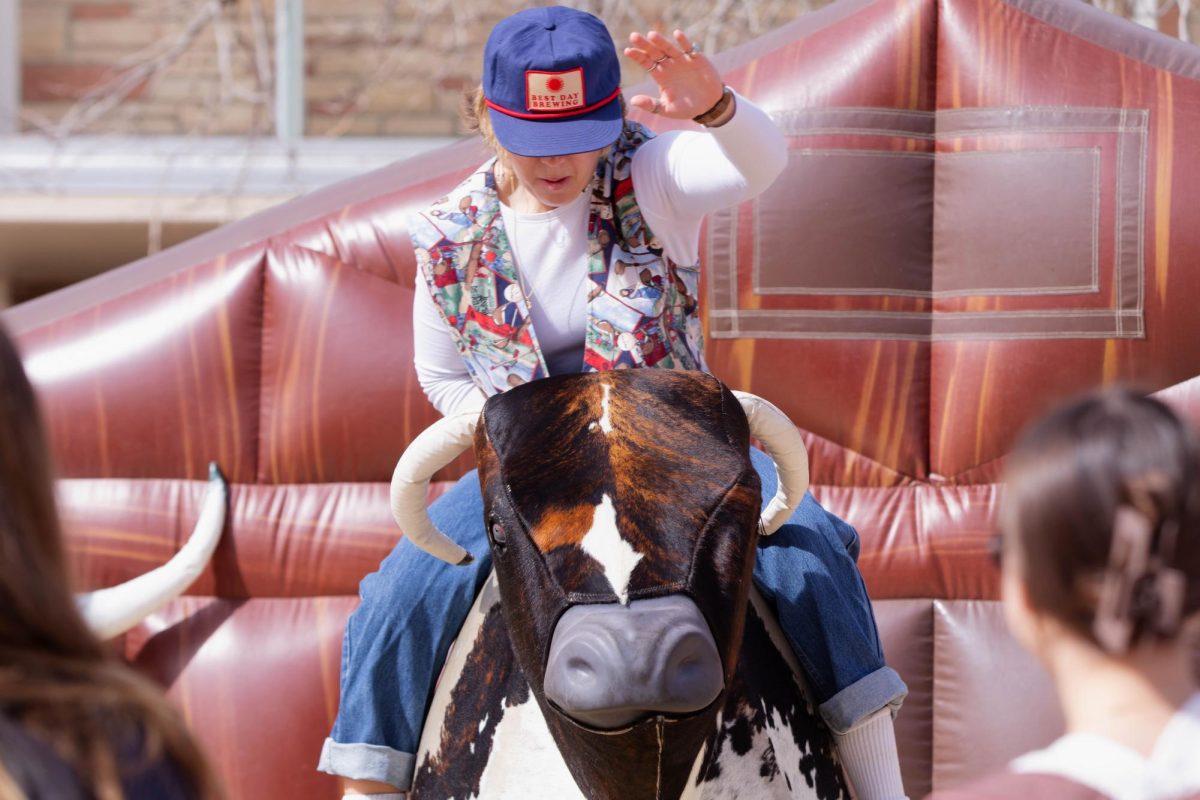 Colorado State University student focuses during mechanical bull ride during ASCSU's Saddle Up and Vote event on the Lory Student Center Plaza at, March 10. "I honestly like this better than the ice skating, it's more interesting." Said Colorado State University student Abbie Blunt.