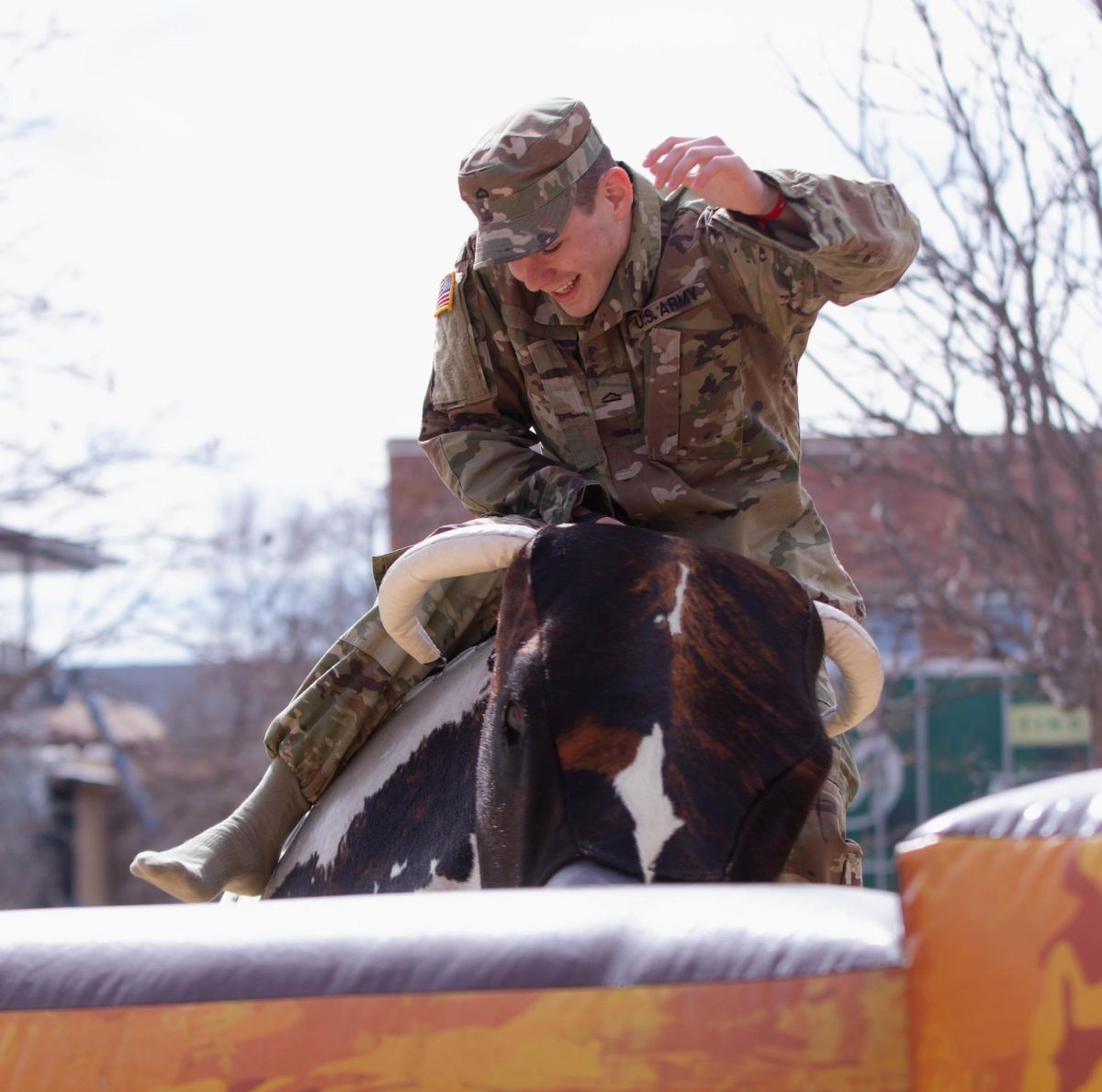 Colorado State University ROTC student holds on during mechanical bull ride during the Saddle Up and Vote event on the Lory Student Center plaza, March 10. "I honestly like this better than the ice skating, it's more interesting." Said Colorado State University student Abbie Blunt
