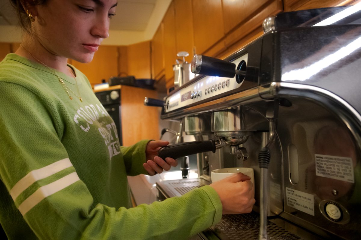 Rylee locks the portafilter into place to begin the espresso extraction process April 1.
