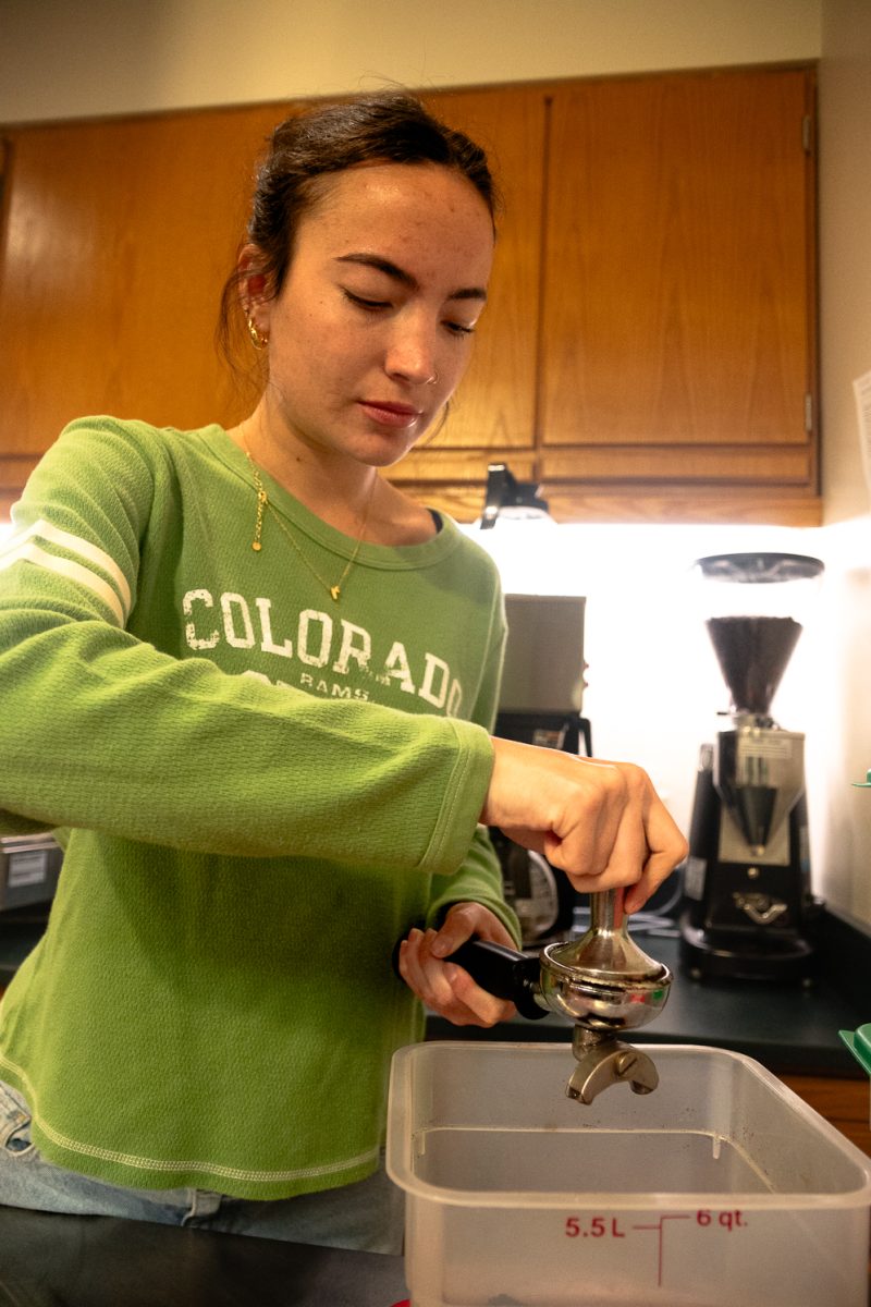 Rylee begins the tamping process of making an espresso April 1. Rylee uses a tamper tool to compress the ground coffee into the portafilter handle, becoming dense to later extract it with the espresso machine.
