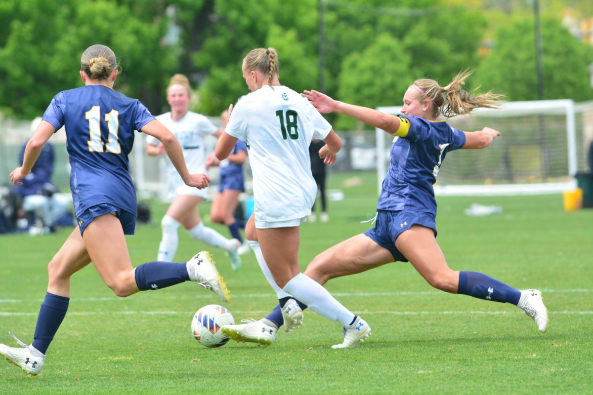 Isabelle Wright dribbling the ball through two Northern Colorado players, there was a foul called and Isabelle score a free kick April 25. Colorado State University defeated UNC 4-0. 