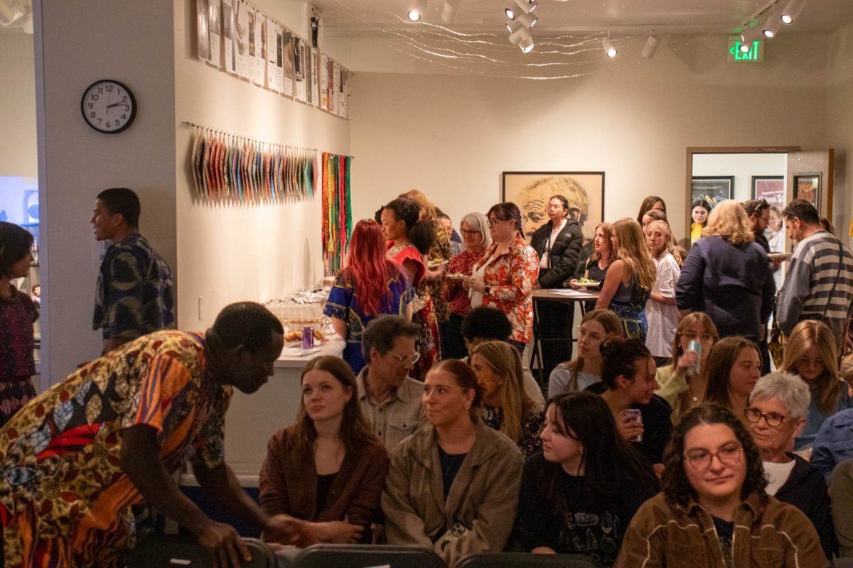 Visitors gather and line up for food at the Gifts from Ghana celebration in the University Center for the Arts April 4.
