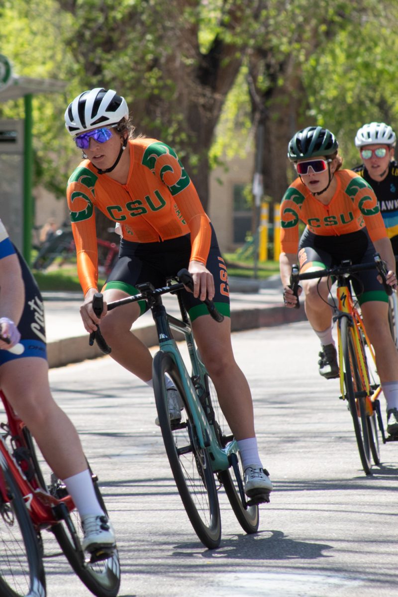 Eleanor ‘Nora’ Dausch and Anna Petr, members of the Colorado State University Club Cycling team, race down Libbie Coy Way during the Oval Criterium race April 18.