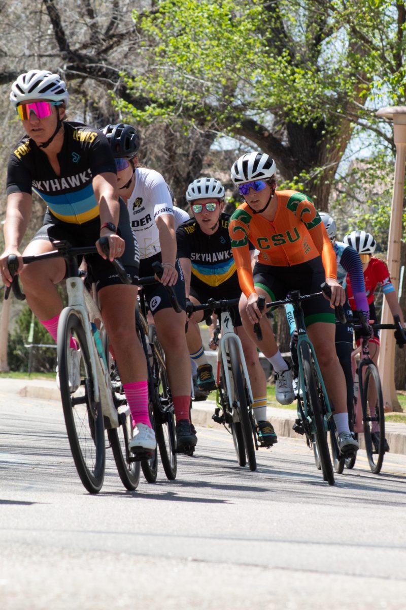 Eleanor ‘Nora’ Dausch, a Colorado State University Club Cycling team member, races other cyclists around the Oval during the Oval Criterium April 18. The race was a 40 minute sprint.