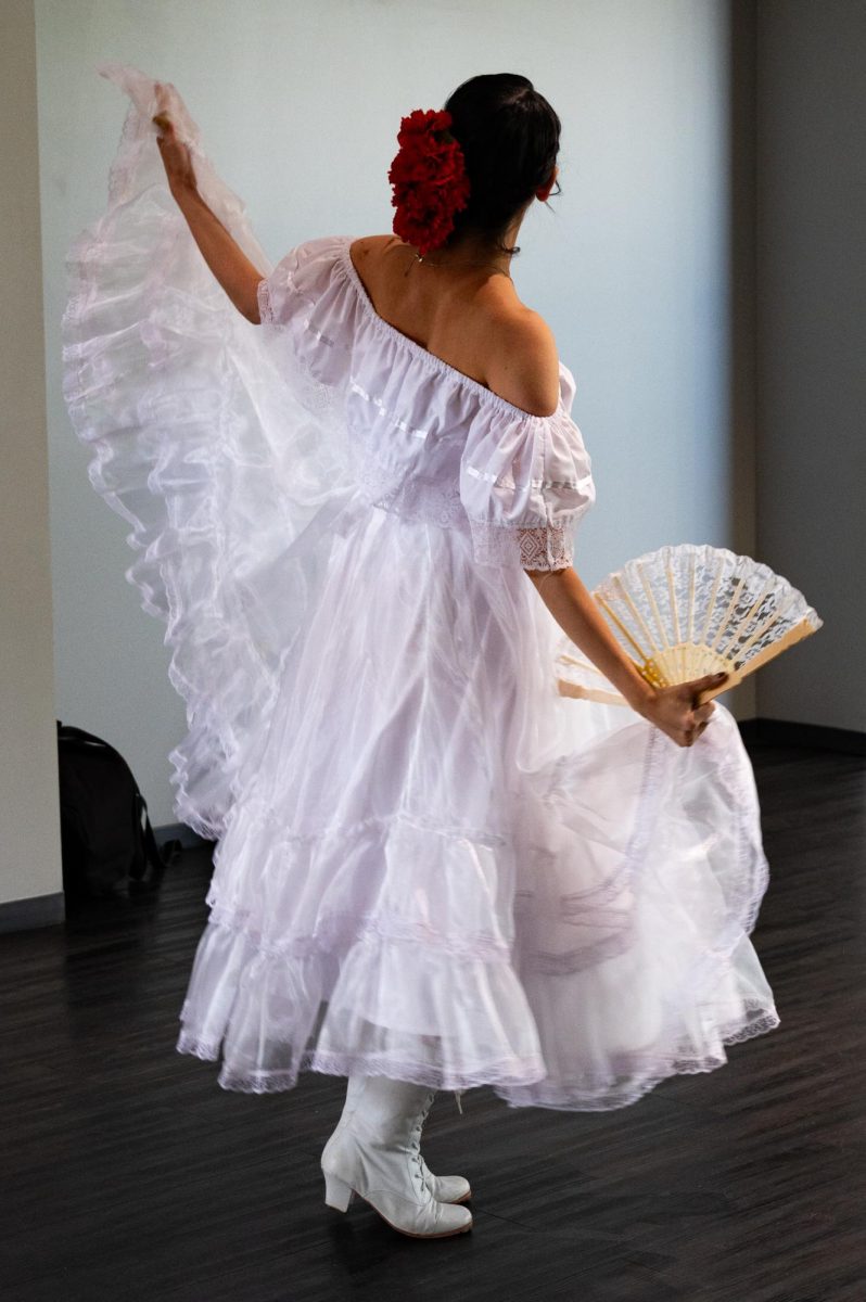 Veronica Wilson, a Baile Folklo Rico dancer, practices her performance for the evening of art and live experiences held at the foothills mall, April 24. Wilson uses her art to tell stories, and to express her feelings around herself and her religion. “When I did my dance I wanted to show a story in it,” Wilson said. “At the beginning I was hiding my face, hiding myself, and I think it was a form of shame. As I’m dancing it’s a way of me learning that I don’t have to hold onto that shame, and I can give it to [God]. And so at the end I am able to reveal myself.”