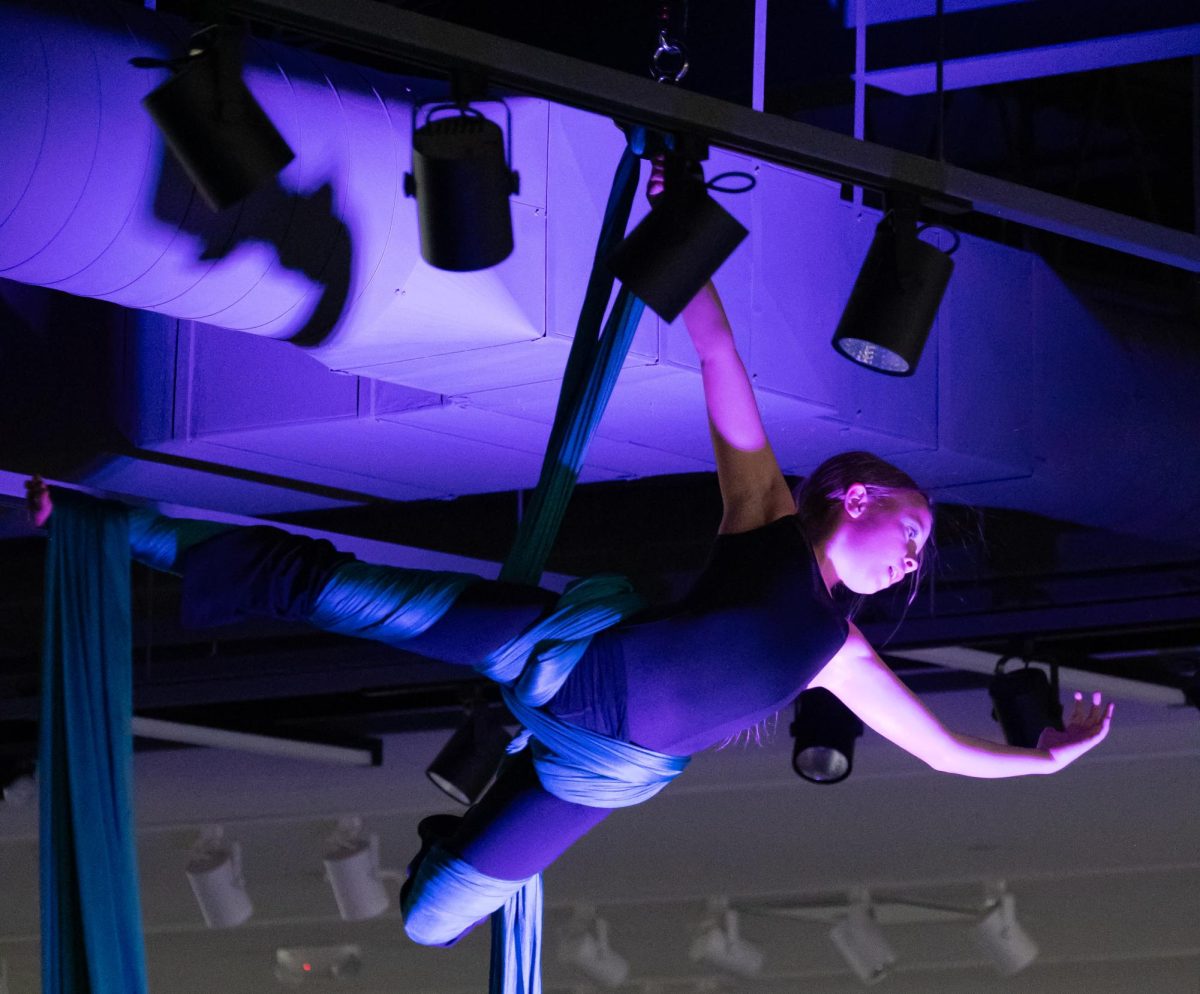Finn Boyle, young aerialist and performer in a traveling trapeze troupe, performs her aerial piece as part of the exhibitions events, April 24. Boyle was excited to participate the exhibition, as she believes that art is a beautiful and fulfilling experience that contributes positively to the community. “I really like bringing everybody together, and showing people that art is one of the most beautiful,” Boyle said. “It just makes me feel really happy, and it fills me with joy. I like the buildup. I like the build up and I like the stomach drop, and like before and after. It’s just super amazing.”