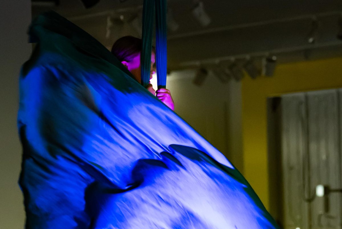 Finn Boyle, young aerialist and performer in a traveling trapeze troupe, performs her aerial piece as part of the exhibitions events, April 24. Boyle was excited to participate the exhibition, as she believes that art is a beautiful and fulfilling experience that contributes positively to the community. “I really like bringing everybody together, and showing people that art is one of the most beautiful,” Boyle said. “It just makes me feel really happy, and it fills me with joy. I like the buildup. I like the build up and I like the stomach drop, and like before and after. It’s just super amazing.”