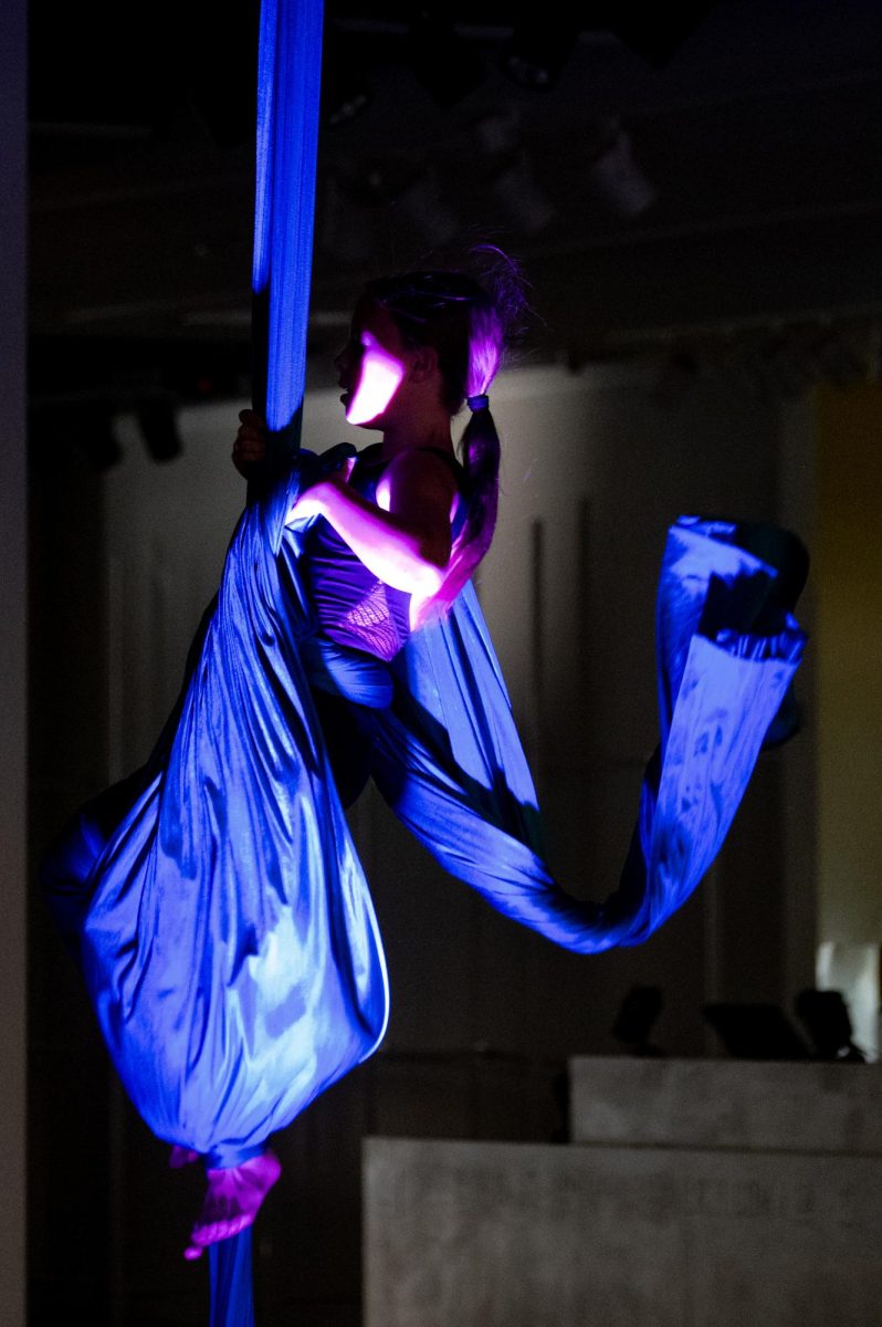 Finn Boyle, young aerialist and performer in a traveling trapeze troupe, performs her aerial piece as part of the exhibitions events, April 24. Boyle was excited to participate the exhibition, as she believes that art is a beautiful and fulfilling experience that contributes positively to the community. “I really like bringing everybody together, and showing people that art is one of the most beautiful,” Boyle said. “It just makes me feel really happy, and it fills me with joy. I like the buildup. I like the build up and I like the stomach drop, and like before and after. It’s just super amazing.”