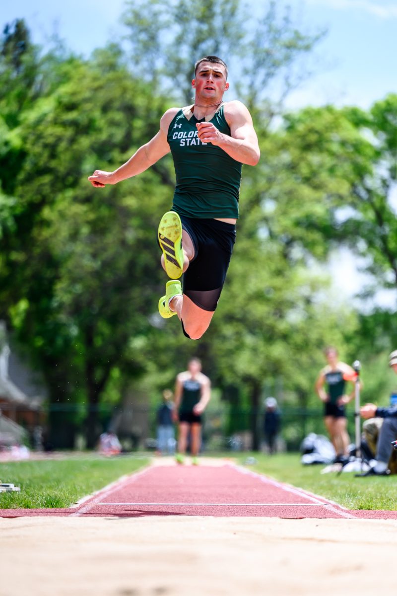Colorado State University track and field athlete Zach Sell leaps into the long jump sand pit during CSU's Border Dual Meet April 25. Sell placed third with a mark of 6.68 meters.