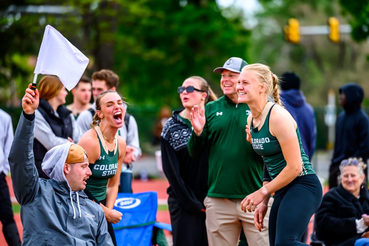 Colorado State University track and field athletes Mackenzii Phillips and Jet Van Der Heijden celebrate Van Der Heijden's personal record-breaking mark of 49.60 meters at CSU's Border Dual Meet April 25.