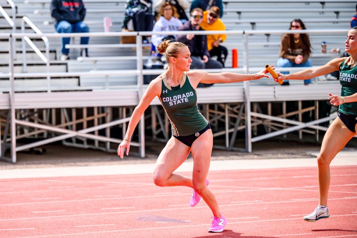 Colorado State University track and field athlete Grace Lanfear takes the baton from Lily Krob during the women's 4x400 meter relay at the end of the CSU Border Dual Meet against the University of Wyoming April 25.