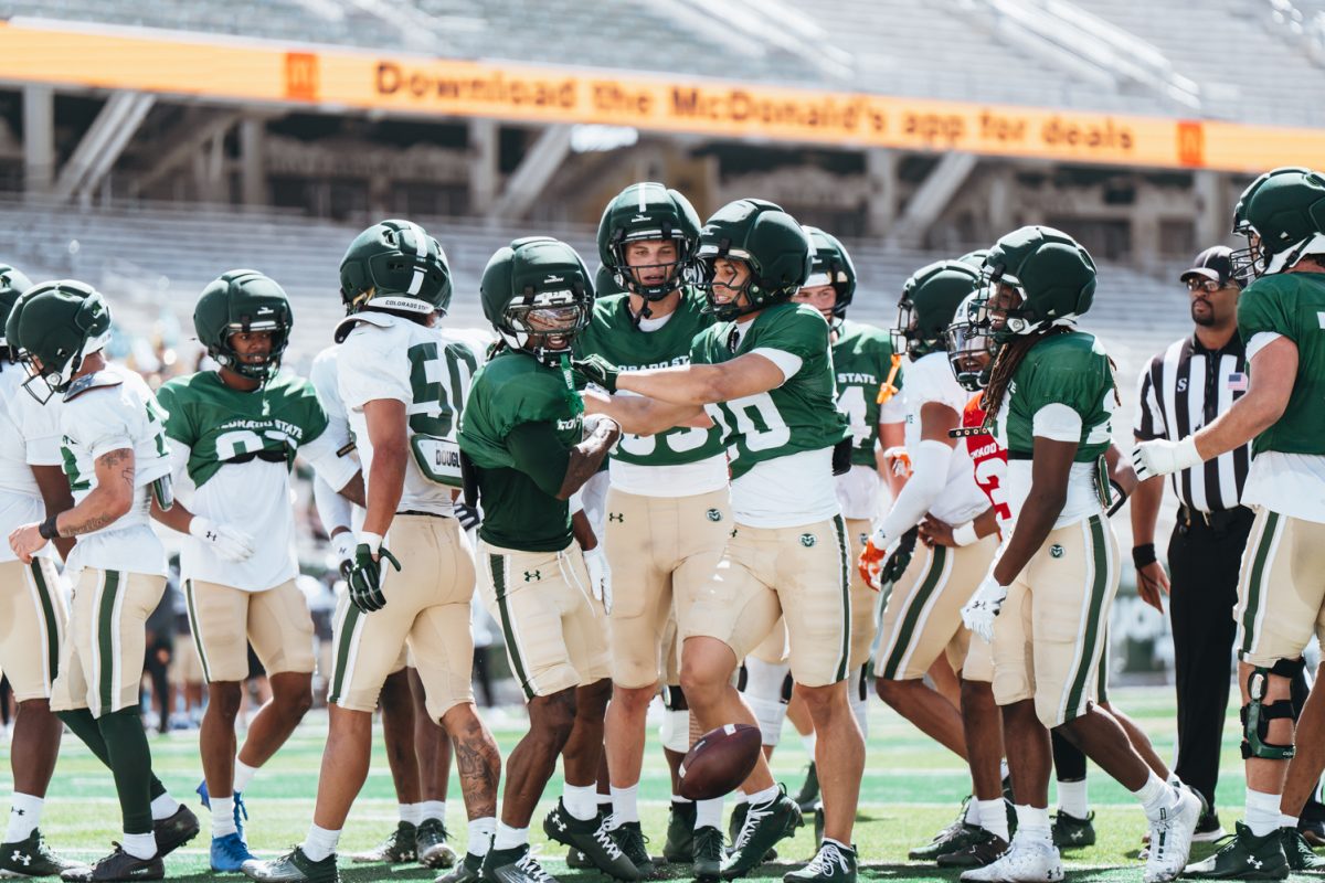 Colorado State University football players celebrate a touchdown together during the Spring Spotlight football practice at Canvas Stadium April 11.