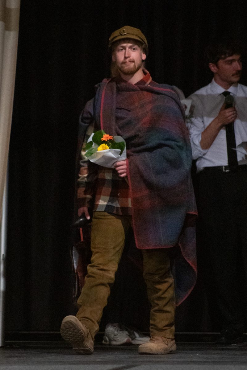 Colby Zur, a senior in apparel design and production, walks onto the runway to be recognized, after the conclusion of Fashion Reframed, Colorado State University Design and Merchandising department’s annual student-run fashion show in the Lory Student Center ballrooms May 1. Zur’s collection Terminus was voted fan favorite by attendees, and was described  as “A narrative and exploration around synthetic and natural fibers,” where the two contrasting groups symbolize technology and tradition respectively.