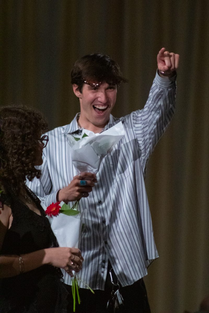Ryan Baker, a senior in apparel design and production, points at the crowd as he walks onto the runway to be recognized, after the conclusion of Fashion Reframed, Colorado State University Design and Merchandising department’s annual student-run fashion show in the Lory Student Center ballrooms May 1. Baker’s collection The Sculpted Worker won Best Collection, and was “inspired by the functional garments depended on every day, designed to protect, support, and last.”