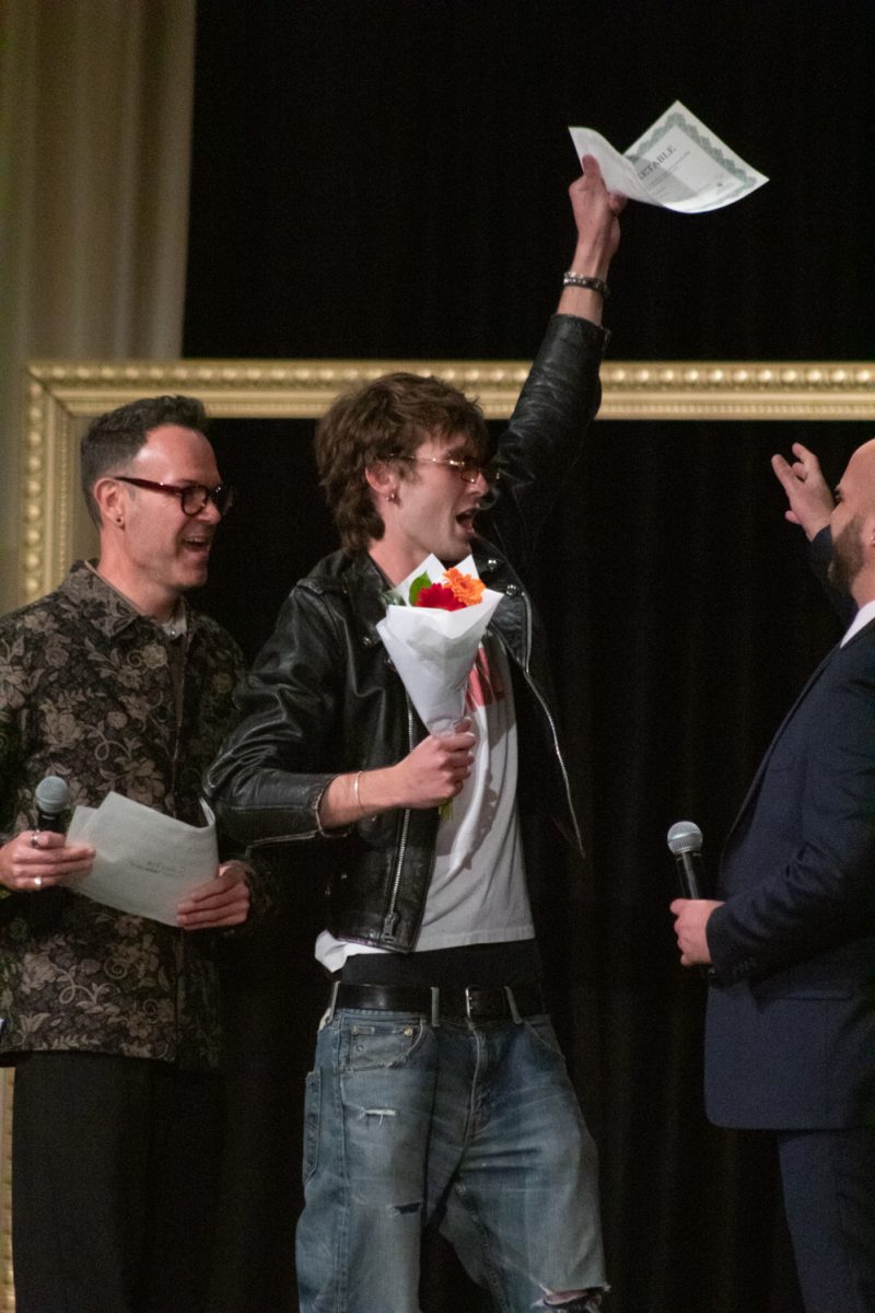 Logan Mourek, a senior in apparel design and production, celebrates as he collects his Most Marketable award after the conclusion of Fashion Reframed, Colorado State University Design and Merchandising department’s annual student-run fashion show in the Lory Student Center ballrooms May 1. Baker’s collection Boyz Boyz Boyz, represented “the ever-shifting mindset of a modern male coming of age through a diverse collection of clothing.”