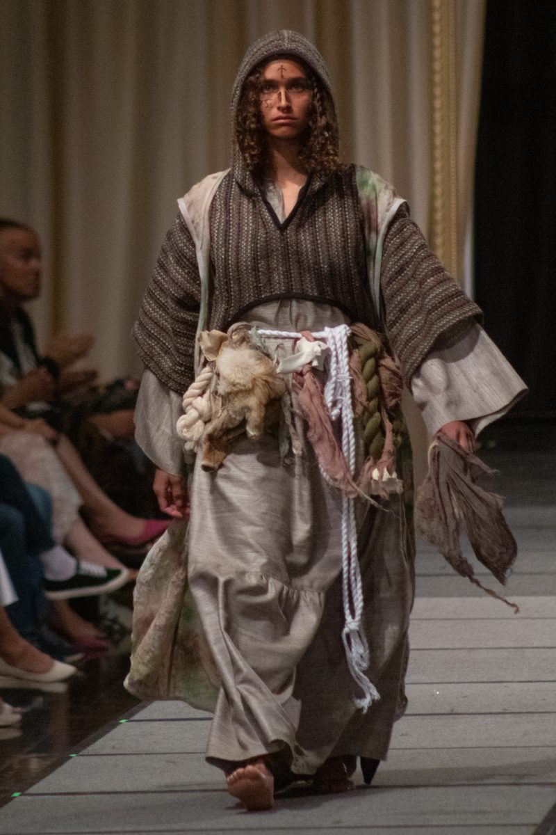 A student models a look designed by Colby Zur, a senior in apparel design and production, as part of his collection Terminus during Fashion Reframed, Colorado State University Design and Merchandising department’s annual student-run fashion show in the Lory Student Center ballrooms May 1. This collection was voted fan favorite by attendees, and was described as “A narrative and exploration around synthetic and natural fibers,” where the two contrasting groups symbolize technology and tradition respectively.