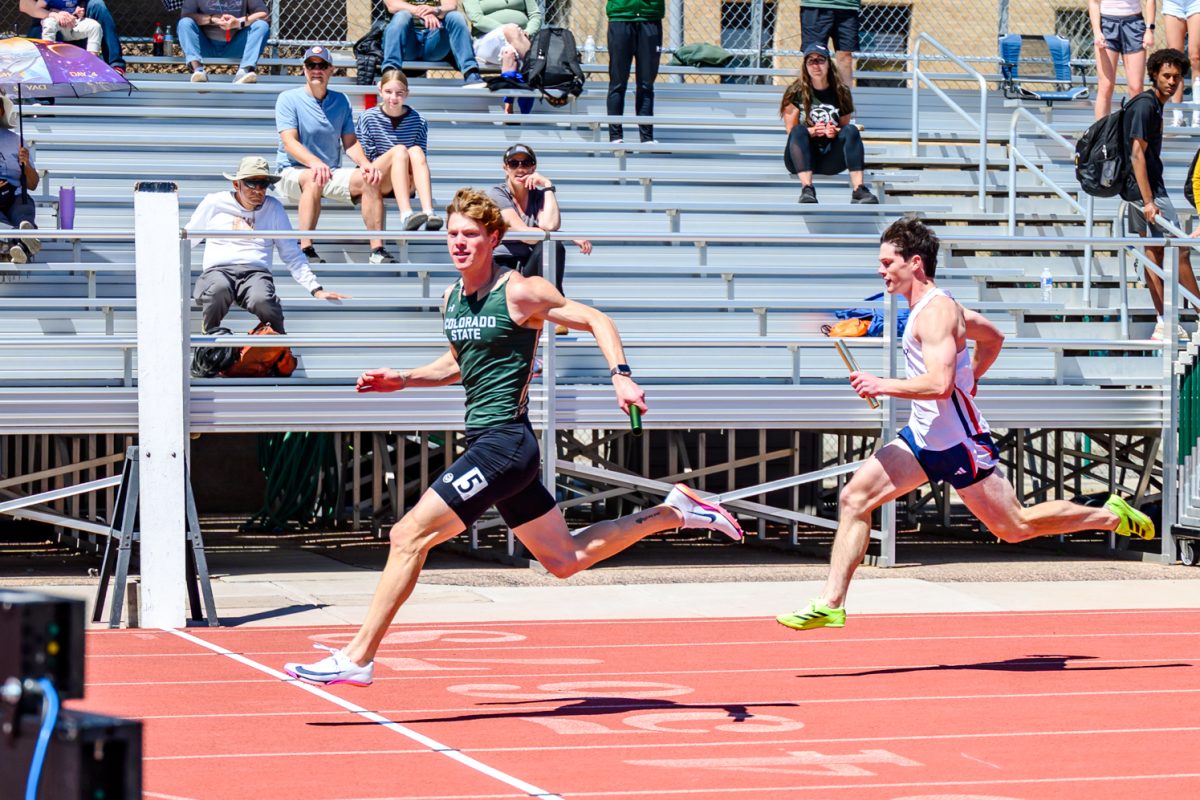 Colorado State University athlete Kenny Carpenter glances at the clock as he runs through the finish line of the men's 4x100 relay May 2. The men's 4x100 team finished first in the Doug Max Invitational with Roman Saiz in the first leg, Wilkins Persichina in the second, Tyler Colwell in the third and Carpenter finishing out the final stretch.