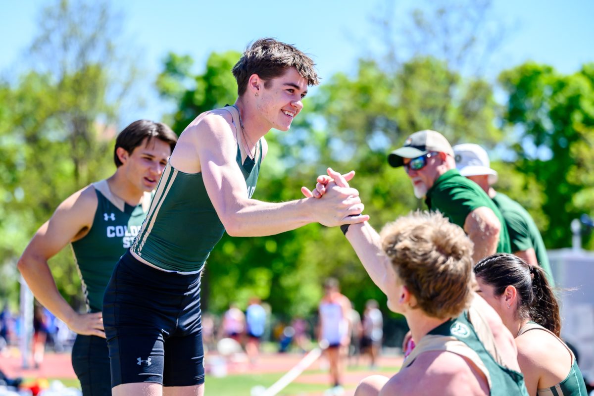 Colorado State University Track and Field athlete Taylor Waters celebrates with his teammates after breaking a program record in men's pole vault with a mark of 5.22 meters May 2.